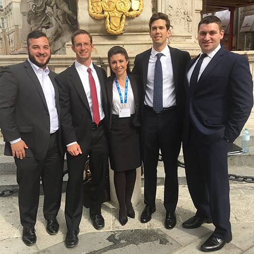 Students in suits in front of a historic building