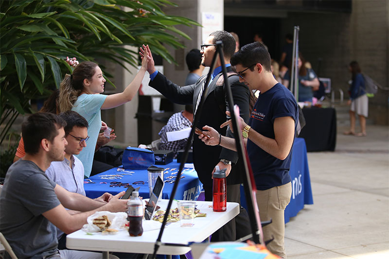 Photo of students high-fiving