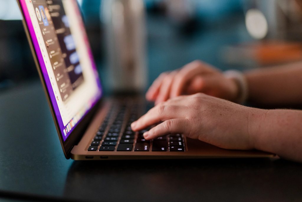 laptop computer with hands on keyboard